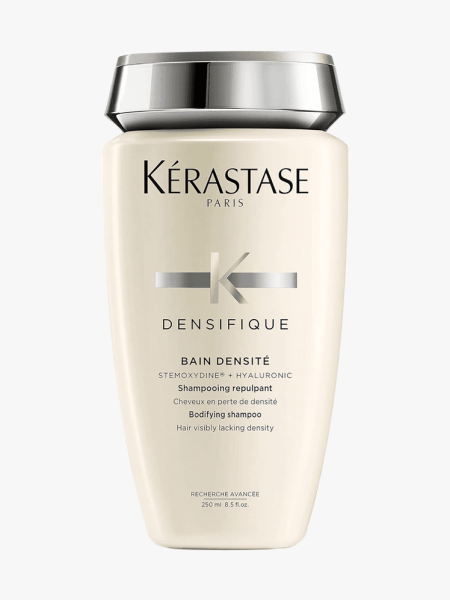 Kérastase Densifique Bain Densité Shampoo in branded tube component with silver cap on a light gray background